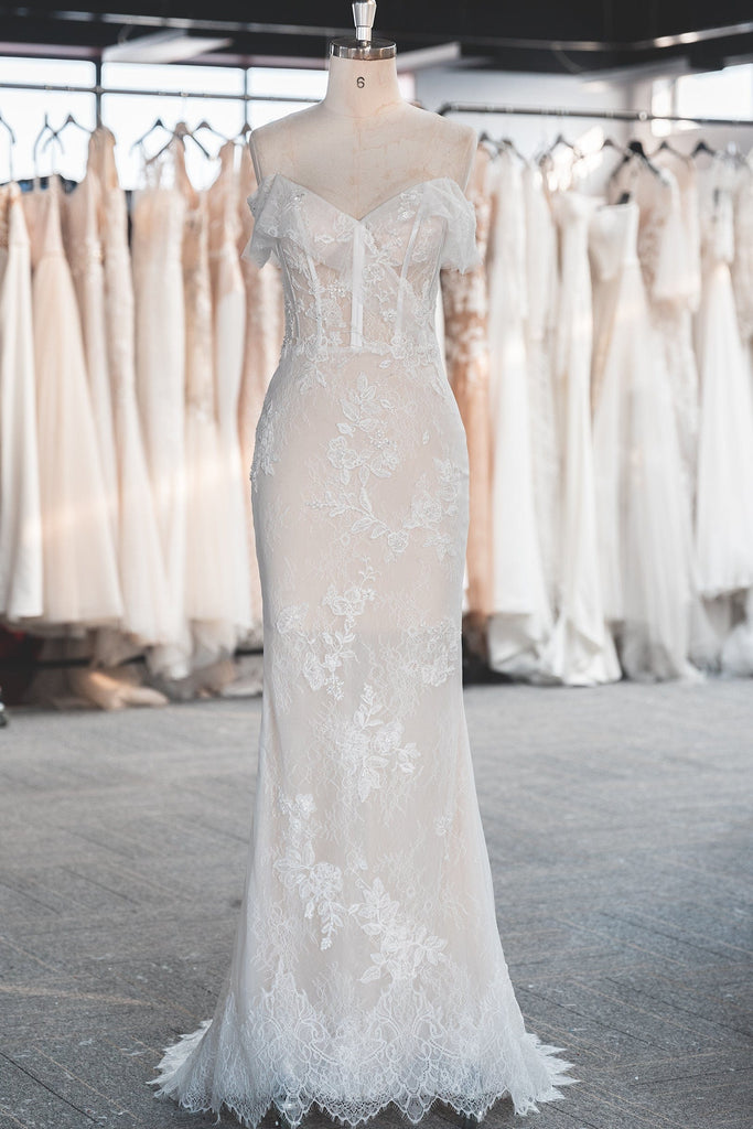 An elegant Sheath Wedding Dress featuring sheer lace with delicate embellishments.
